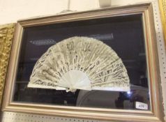 A framed lace and mother of pearl fan decorated with sequined decoration CONDITION REPORTS Fan is