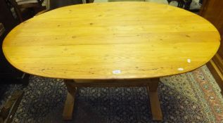 A modern pine oval dining table