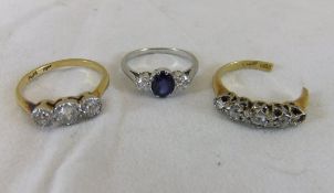 An 18ct gold and platinum ring set with three white stones,