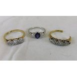 An 18ct gold and platinum ring set with three white stones,