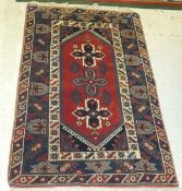 A Caucasian rug, the three central star shaped medallions in blue, red, cream and madder,