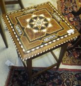 A mid 20th Century Moorish ivory and inlaid square topped table on square tapering supports united