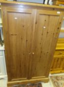 A modern pine two door wardrobe/cupboard