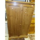 A modern pine two door wardrobe/cupboard