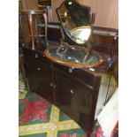 A modern mahogany chiffonier with concave front, a shield shaped toilet mirror,