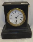 A circa 1900 ebonised pottery cased French mantel clock with circular enamelled dial and Roman