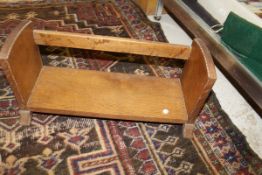 An early 20th Century carved oak book trough in the Cotswold School Arts & Crafts manner