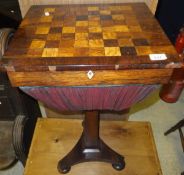 An early Victorian rosewood and inlaid games top sewing table on pedestal tripod base and squat bun