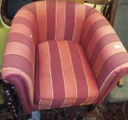 A modern tub chair with red and gold striped upholstery