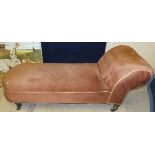 A Victorian chaise longue with salmon pink upholstery on ringed and turned supports to china