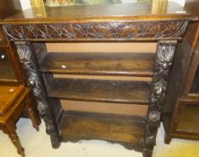 A Victorian oak open book case with carved decoration in the Gothic Revival taste CONDITION