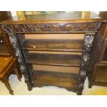 A Victorian oak open book case with carved decoration in the Gothic Revival taste CONDITION