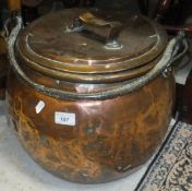 A 19th Century copper cauldron with iron handle and copper lid