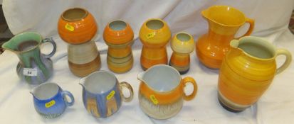 Four Shelley pottery vases of bulbous form with ribbed bodies decorated in orange and yellow,