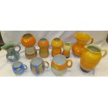 Four Shelley pottery vases of bulbous form with ribbed bodies decorated in orange and yellow,