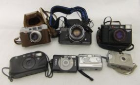 A box of assorted cameras to include PALM 4, Canon AF35 ML, and an Olympus OM1 CONDITION REPORTS