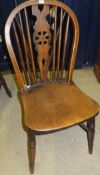 A set of seven (five plus two) wheel back dining chairs
