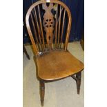 A set of seven (five plus two) wheel back dining chairs