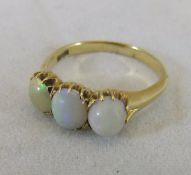 A 14ct gold and opal set dress ring CONDITION REPORTS Ring size sits between "Q" and "R".  Opals are