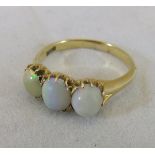A 14ct gold and opal set dress ring CONDITION REPORTS Ring size sits between "Q" and "R".  Opals are