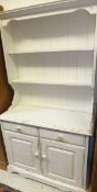 A white painted dresser with plate rack over two drawers and two cupboard doors,