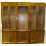 A large modern walnut breakfront book case in the George III taste