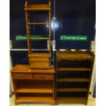 A modern yew wood book case with two drawers over adjustable shelves, a small rubberwood book shelf,
