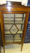 An Edwardian mahogany and inlaid display cabinet with painted decoration on square supports