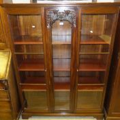 A mahogany two door display cabinet enclosing adjustable shelves,