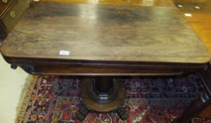 An early Victorian rosewood card table, the rounded rectangular fold-over top on a faceted