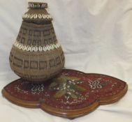 A Kenyan Samburu Tribe basket work and cowry shell decorated milk container and cover,