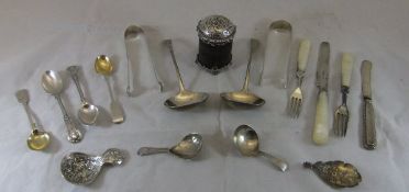 A box containing various silver and white metal wares, to include three caddy spoons, sugar nips,