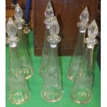 A set of six 19th Century Continental glass conical spirit decanters with stoppers,