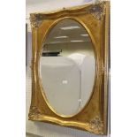 A rectangular gilt decorated wall mirror with oval plate
