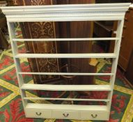 A white painted pine plate rack with drawers to base