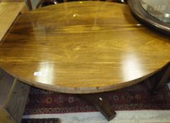 A 19th Century rosewood oval centre table on octagonal pedestal to shaped base and casters