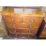 A Victorian mahogany chest of two short over three long drawers with turned wooden handles,