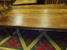 An Indian hardwood rectangular dining table with iron nails and bandings on turned legs