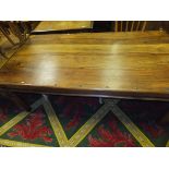 An Indian hardwood rectangular dining table with iron nails and bandings on turned legs