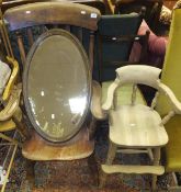 An early 20th Century carver stick back kitchen chair, an oval wall mirror, a child's high chair,