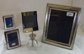 A silver photograph frame, three plated photograph frames,