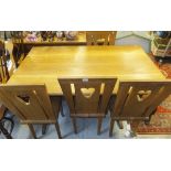 An oak refectory table and four chairs with pierced loveheart decoration to the back splats