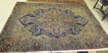 A Persian carpet, the central floral medallion on a blue and cream ground with all over floral