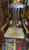 A set of six early 20th Century oak slat back rush seat dining chairs on bobbin turned supports (4
