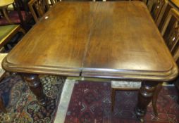 A Victorian mahogany rounded rectangular extending dining table with extra leaf raised on turned