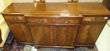 A Brights of Nettlebed mahogany breakfront sideboard in the George III manner, the top cross