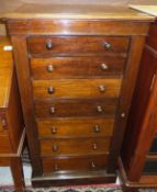 A Victorian mahogany Wellington chest of seven drawers with turned wooden handles, on a plinth