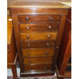 A Victorian mahogany Wellington chest of seven drawers with turned wooden handles, on a plinth