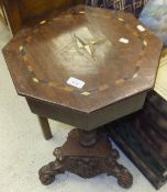 A mahogany and inlaid octagonal work table on associated barley-twist pedestal to carved tripod