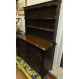A modern oak dresser in the Old Charm manner with two tier boarded plate rack over two drawers and
